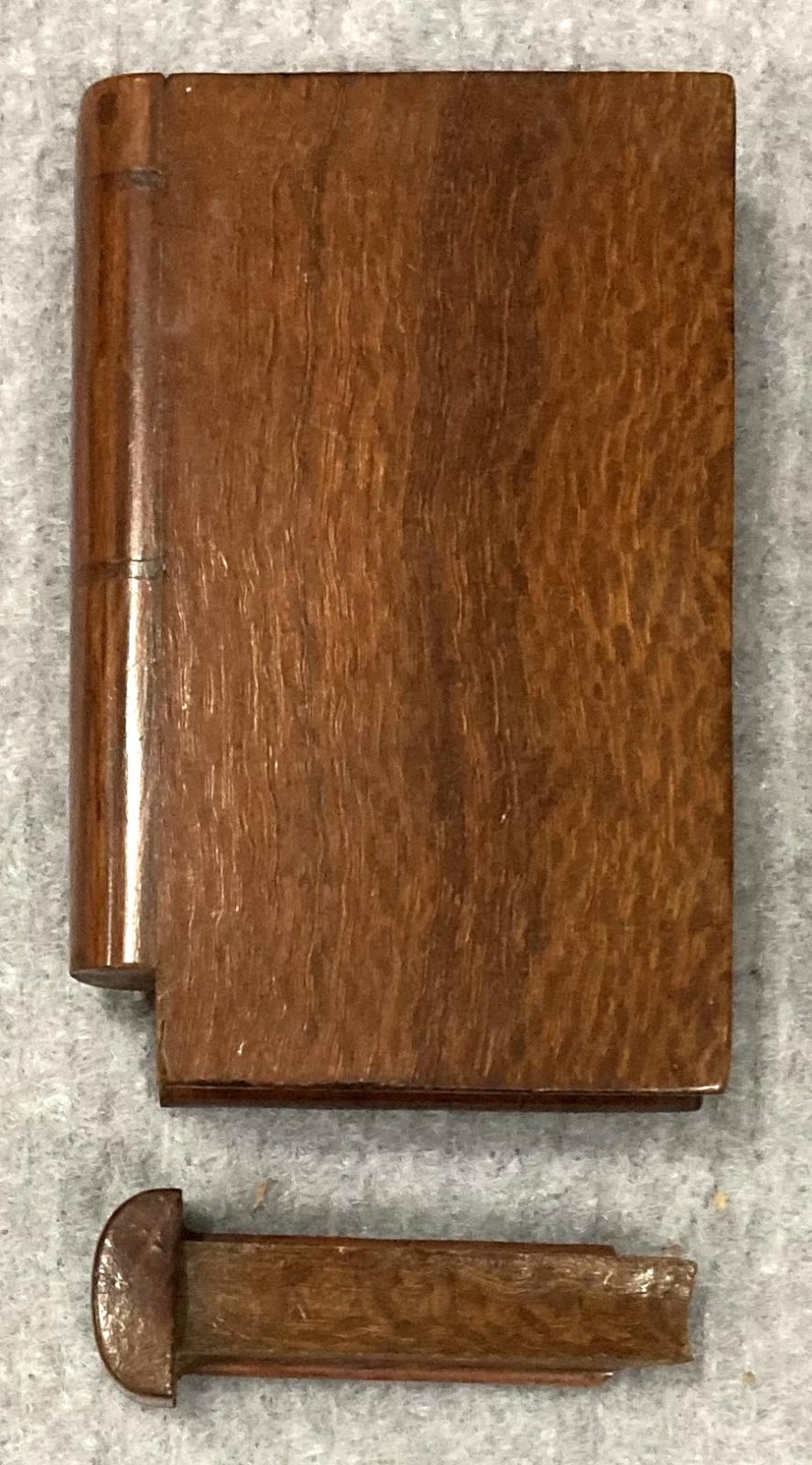 Top view of open souvenir timber book showing removed portion