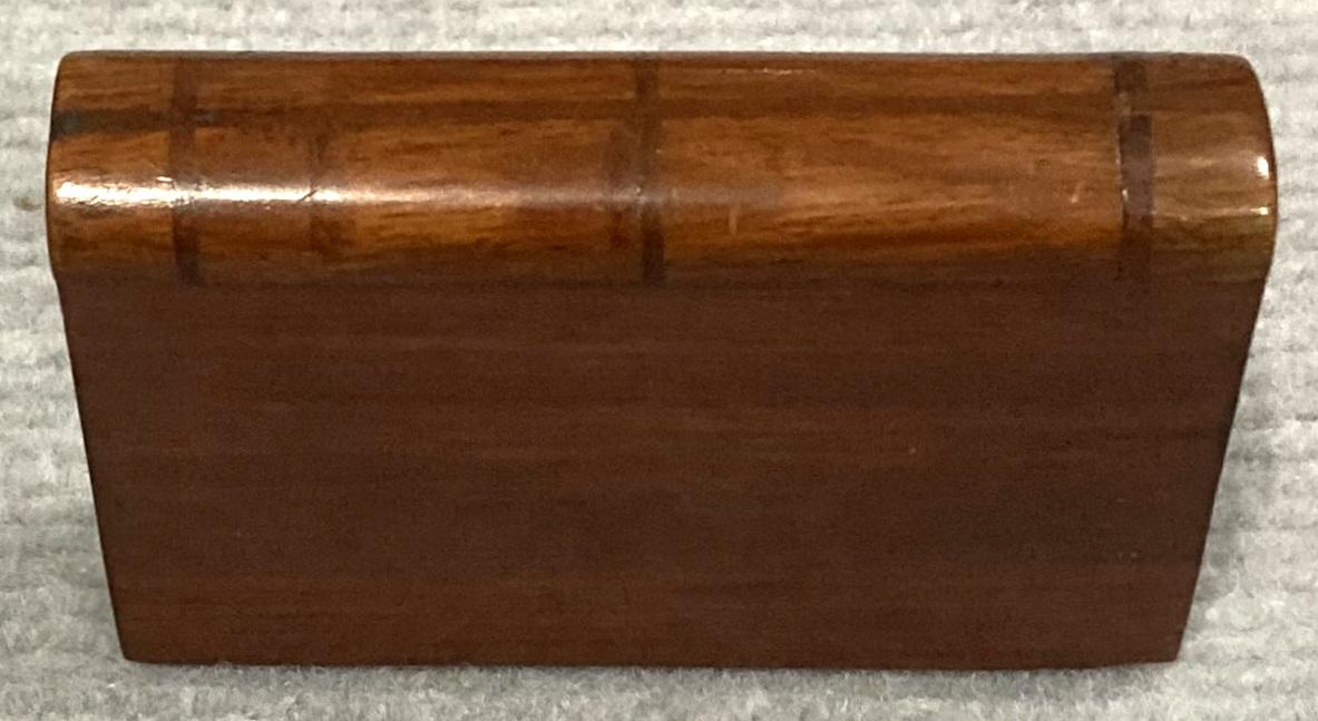View of spine of closed souvenir timber book with hidden opening 