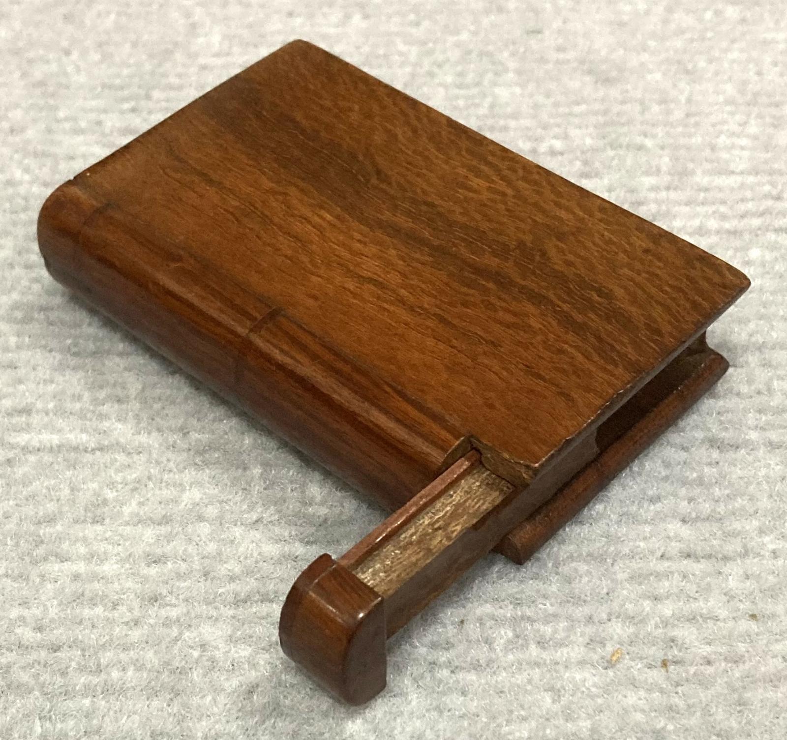 Oblique view showing open souvenir timber book 