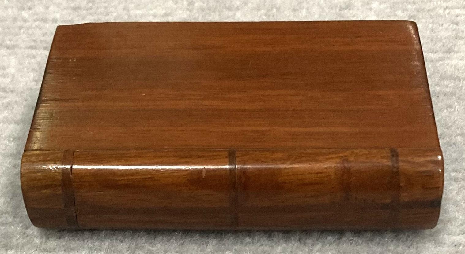 Side view of closed souvenir timber book with hidden opening