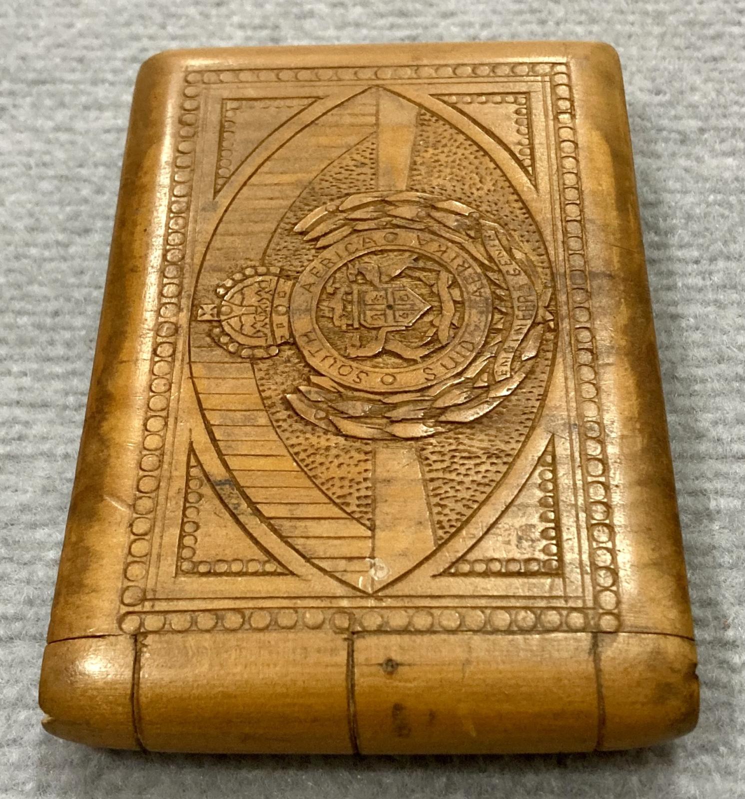End view of souvenir timber case featuring carved South African Engineers badge
