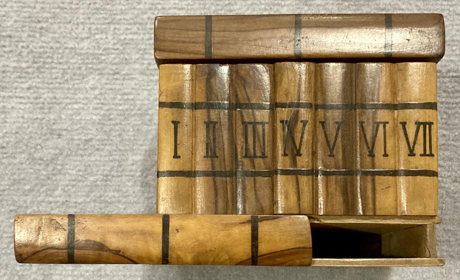 Front view of souvenir olive wood jewellery box showing secret panel partly slid across