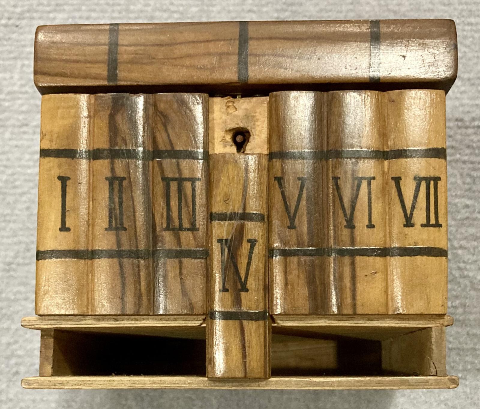 Front view of souvenir olive wood jewellery box showing secret panel removed, revealing keyhole