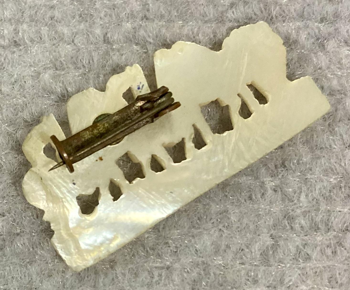 Reverse oblique view of Mother of Pearl camel brooch sent from Bethlehem by Theophilus Thomas Walters