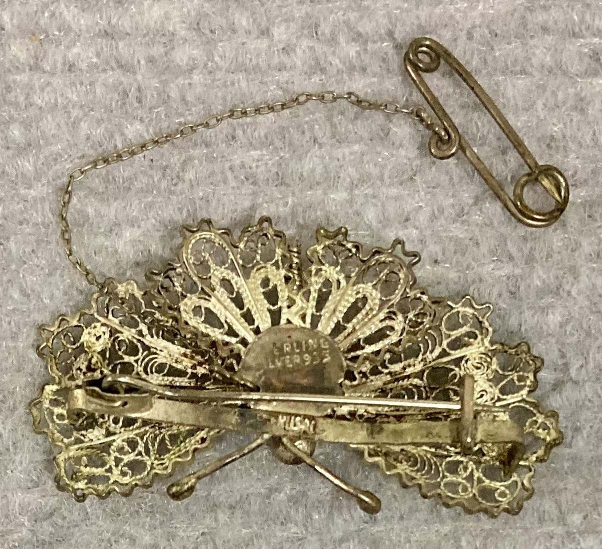 Close up of reverse of silver filagree butterfly brooch showing silver stamp