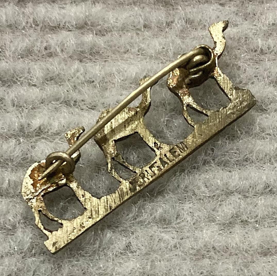Reverse oblique view of metal camel brooch sent from Jerusalem by Stanley Richard Steele