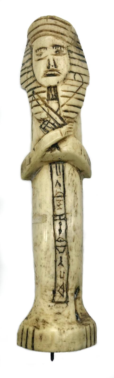 Carved camel bone in the form of an Egyptian shabti
