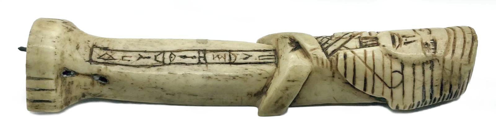 Other side of carved camel bone in the form of an Egyptian shabti