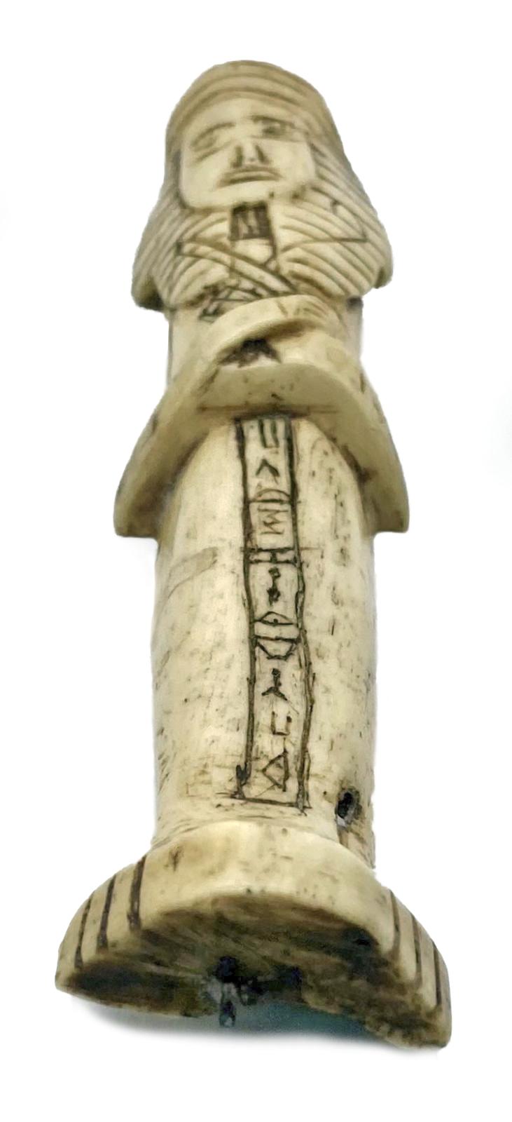 View from base of carved camel bone in the form of an Egyptian shabti