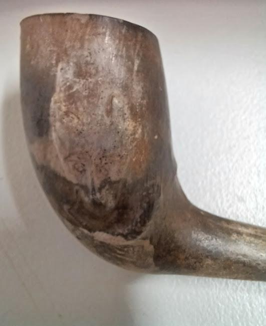 Close up of wolf engraving on pipe bowl
