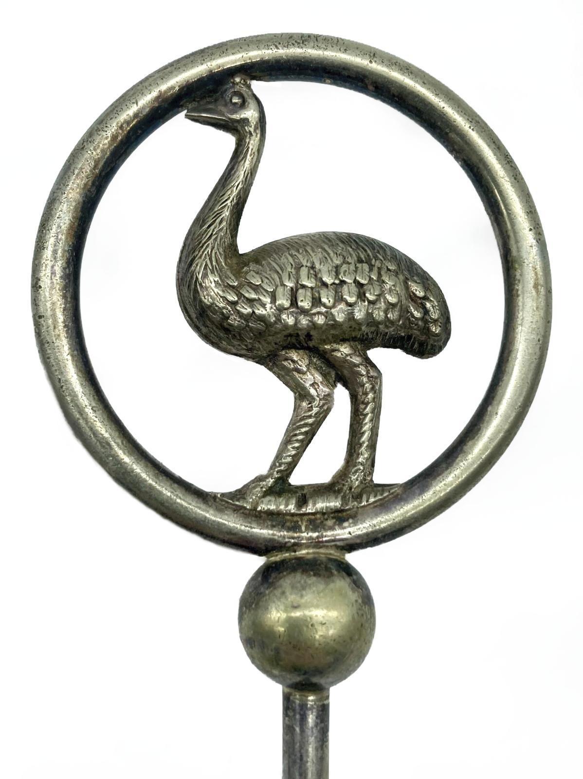 Close up of silver plated trident bread fork with decorative top - emu