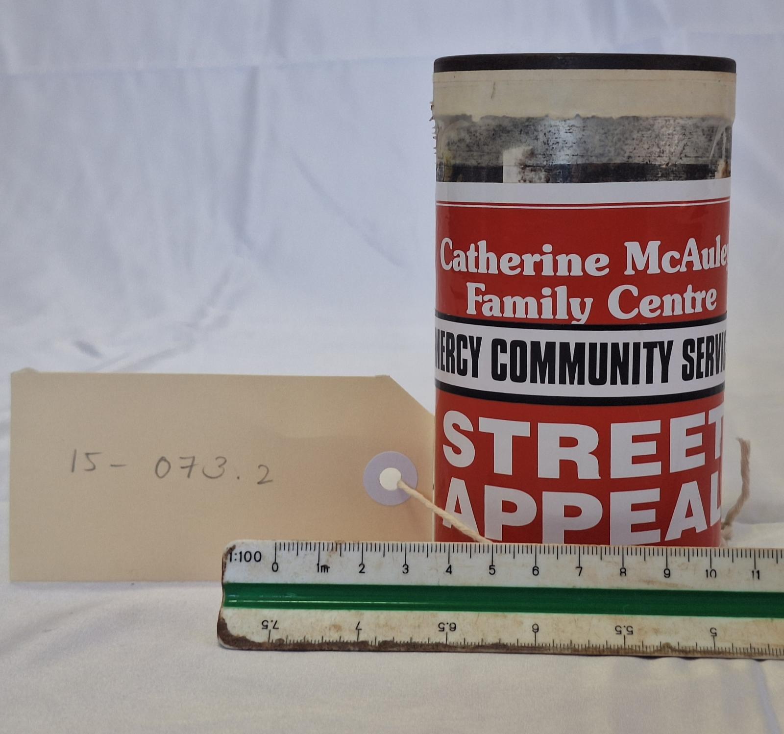 15-073.2 - Collection tin with scale and tag image.