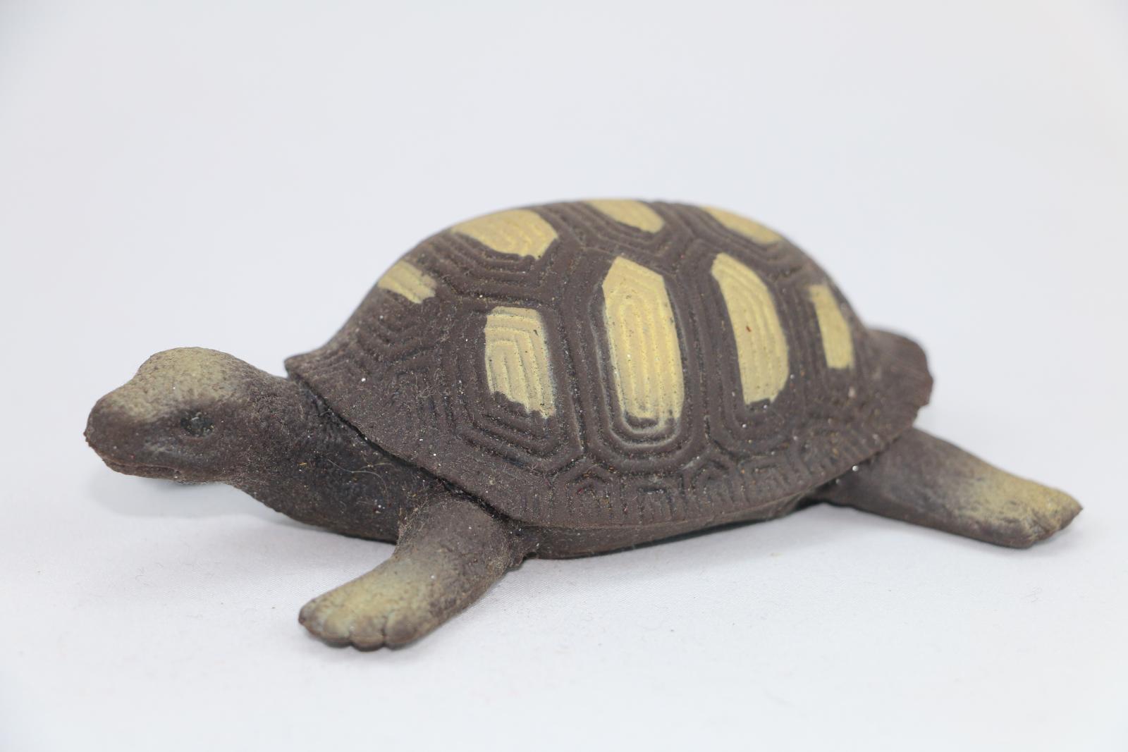 Silicone toy turtle, brown with lighter brown decorations along the shell.
