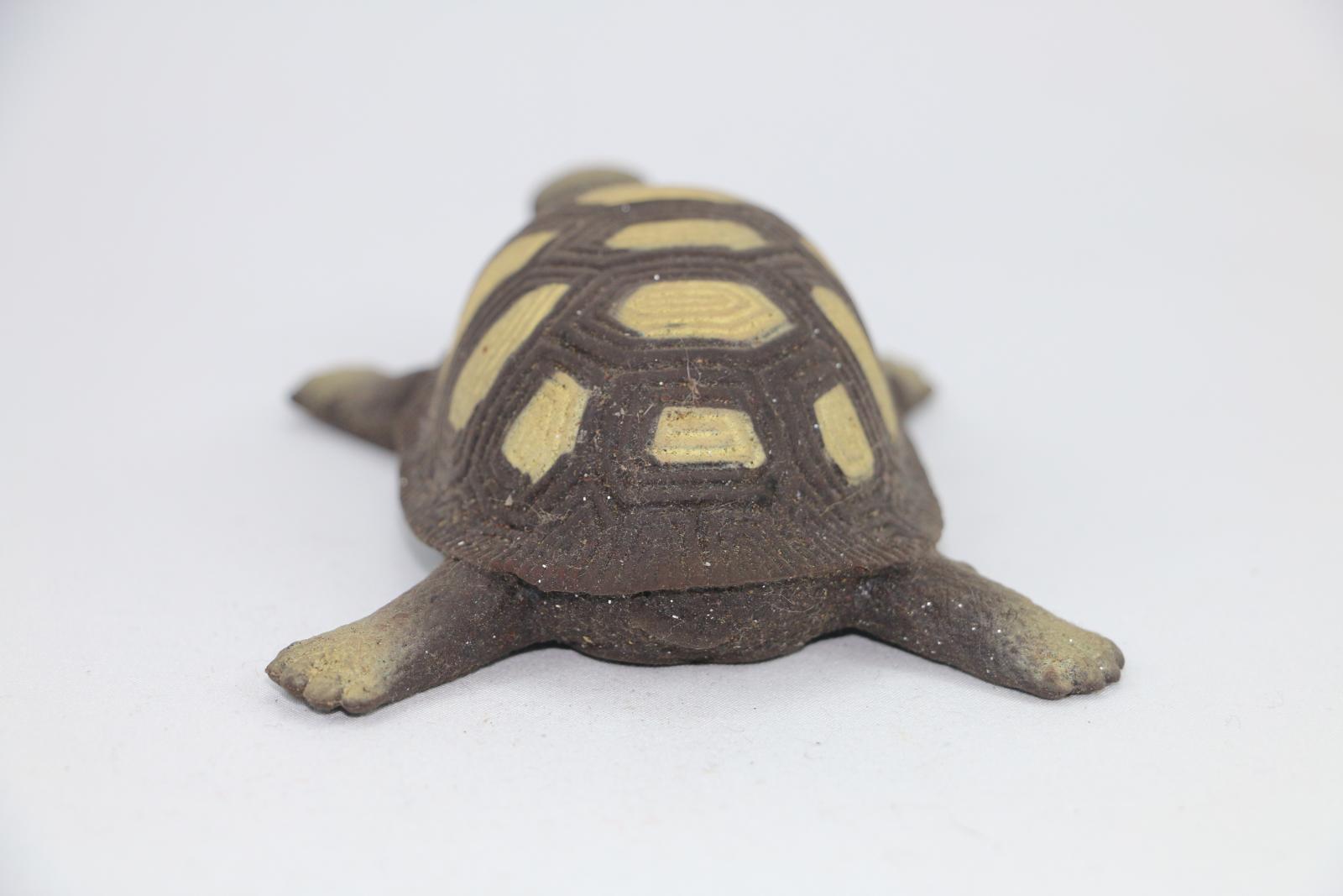 Silicone toy turtle, brown with lighter brown decorations along the shell.
