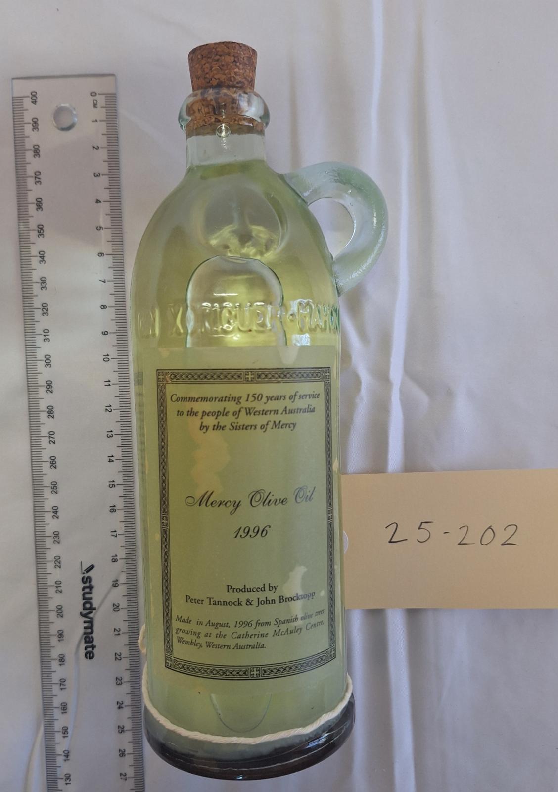 25-202 Mercy olive oil 1996 with scale and tag image