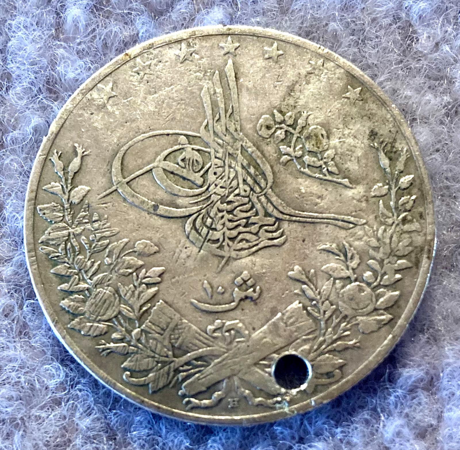Reverse of WWI identity disc made from a coin showing coin right way up