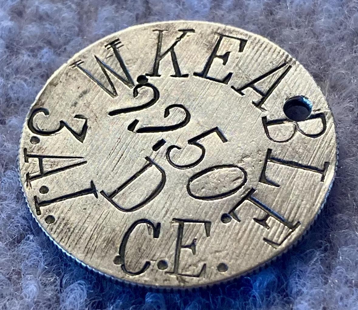 Other oblique view of WWI identity disc made from a coin for Private William Keable