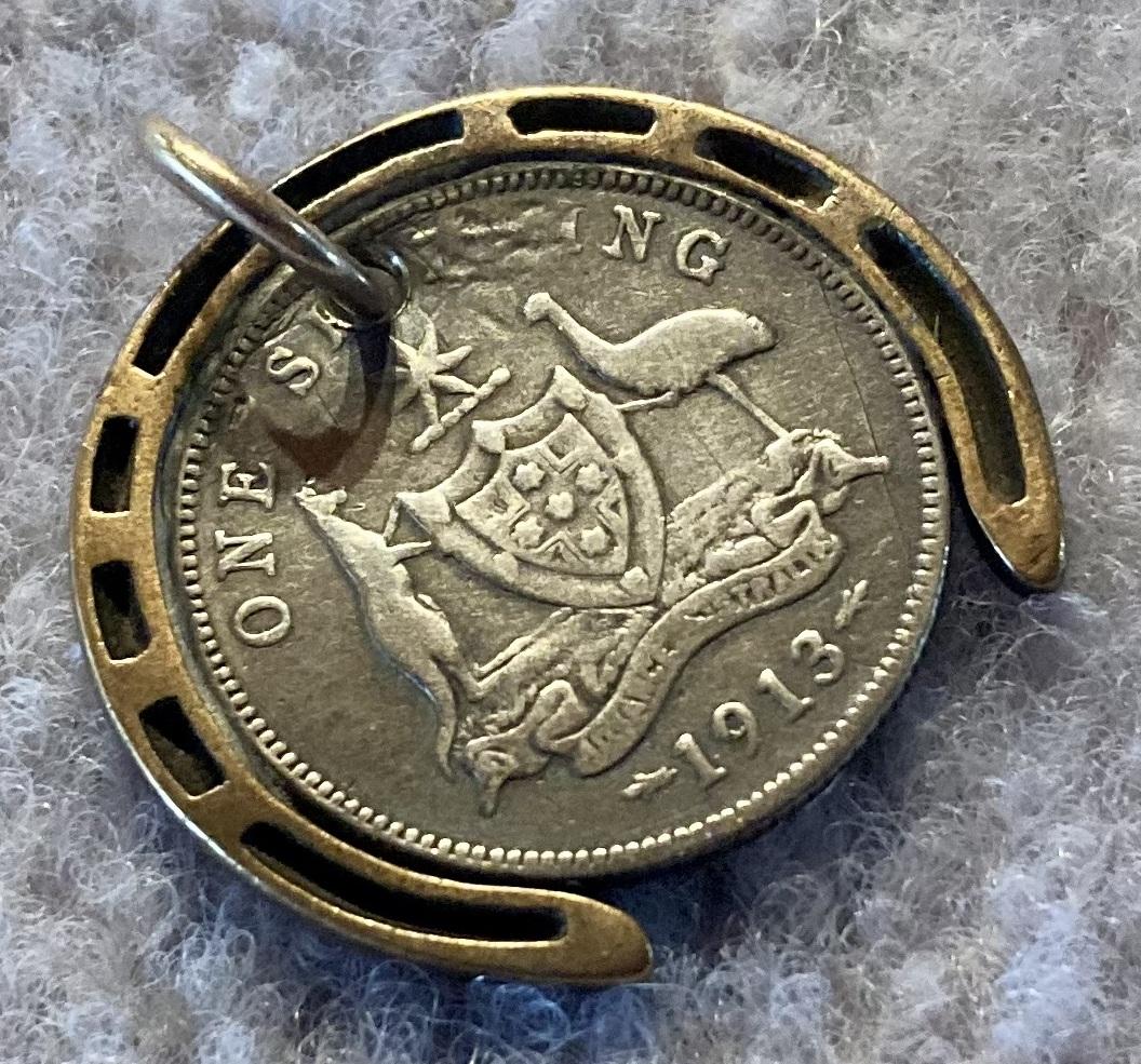 Oblique view of WWI era good luck pendant in form of horseshoe