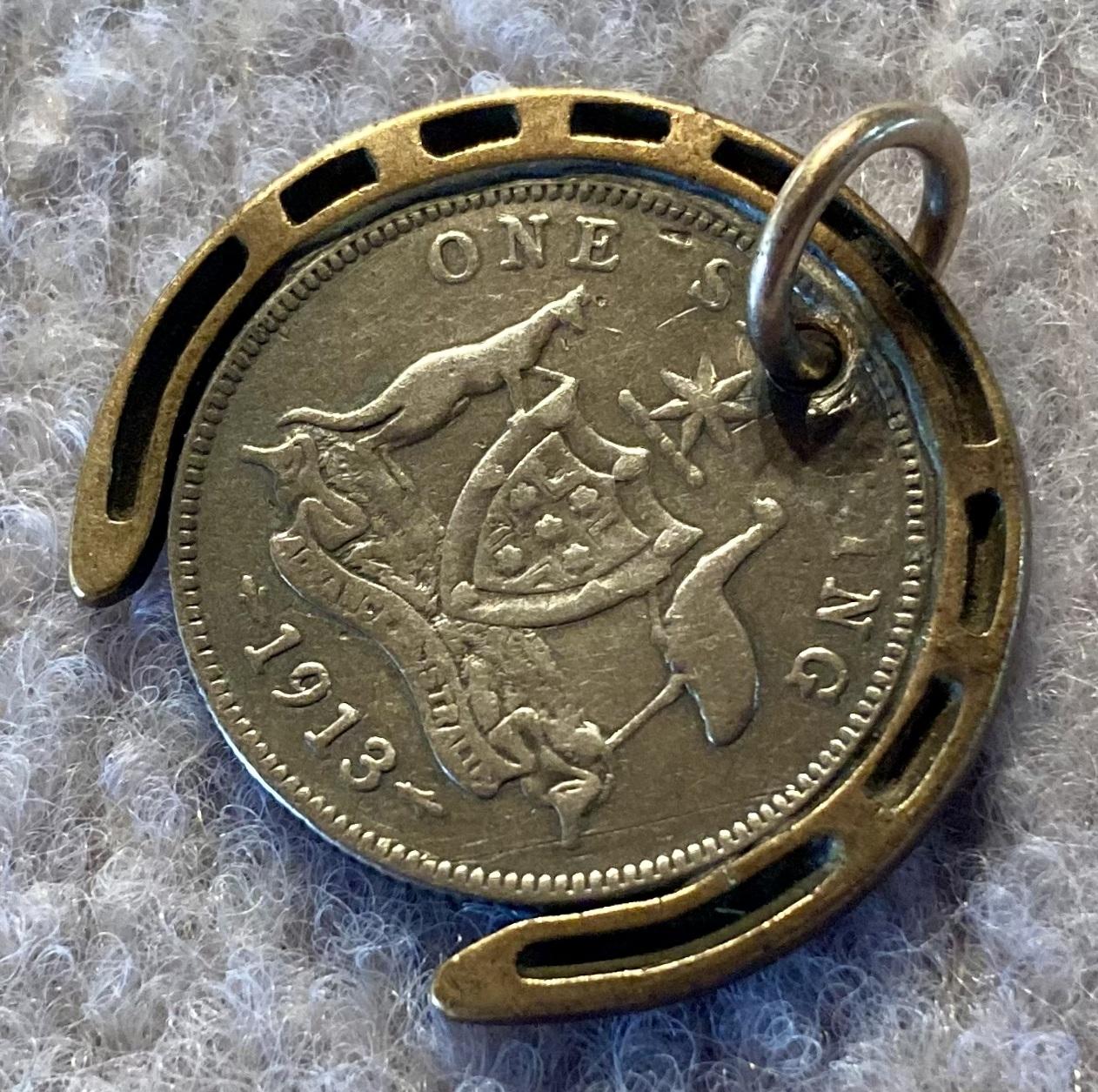 Other oblique view of WWI era good luck pendant in form of horseshoe