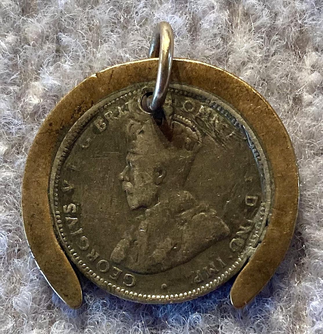 Reverse of WWI era good luck pendant in form of horseshoe