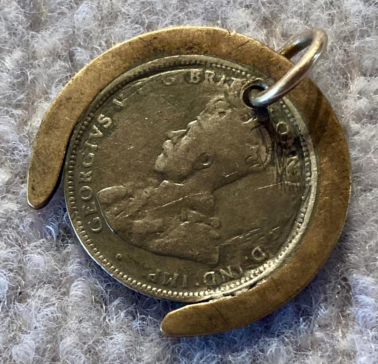 Other oblique view of reverse of WWI era good luck pendant in form of horseshoe
