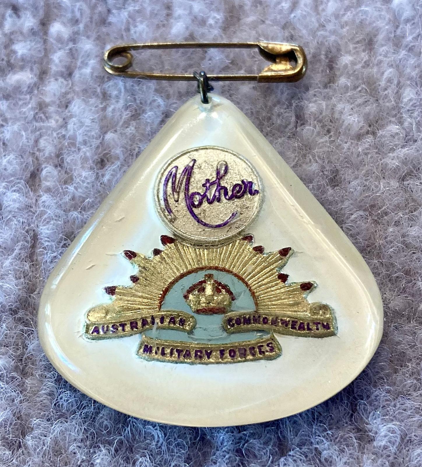 Oblique view of Perspex sweetheart brooch depicting rising sun badge - blue