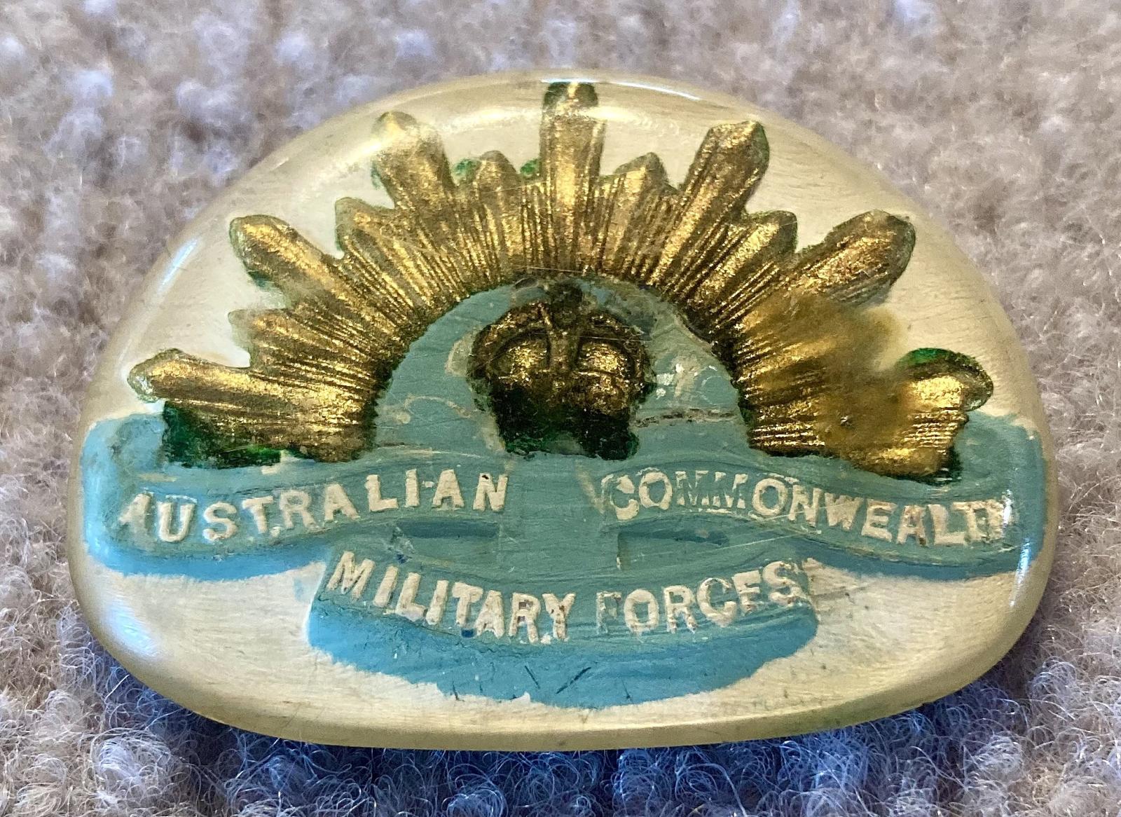 Oblique view of Perspex sweetheart brooch depicting rising sun badge - blue and gold