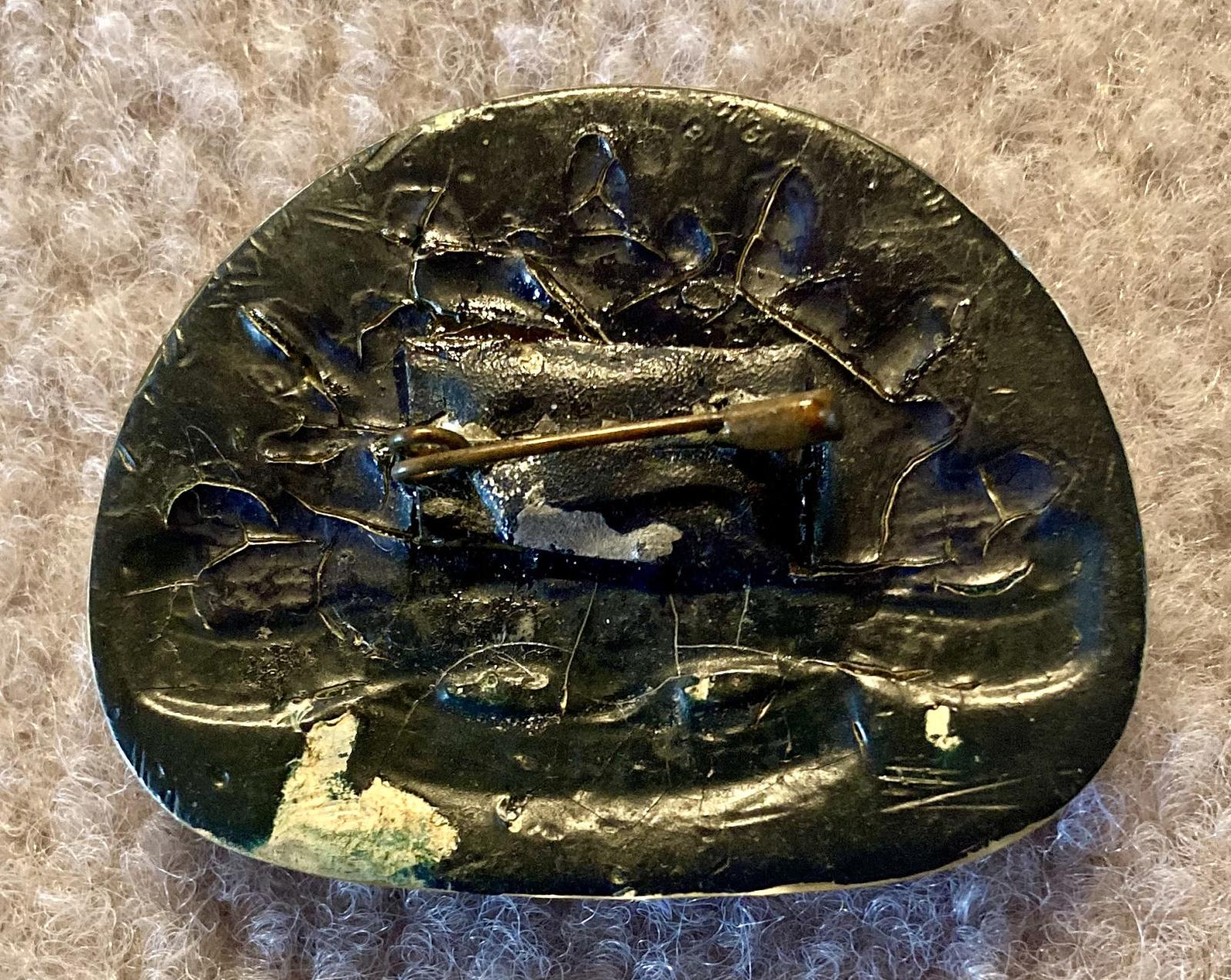 Reverse of Perspex sweetheart brooch depicting rising sun badge - blue and gold