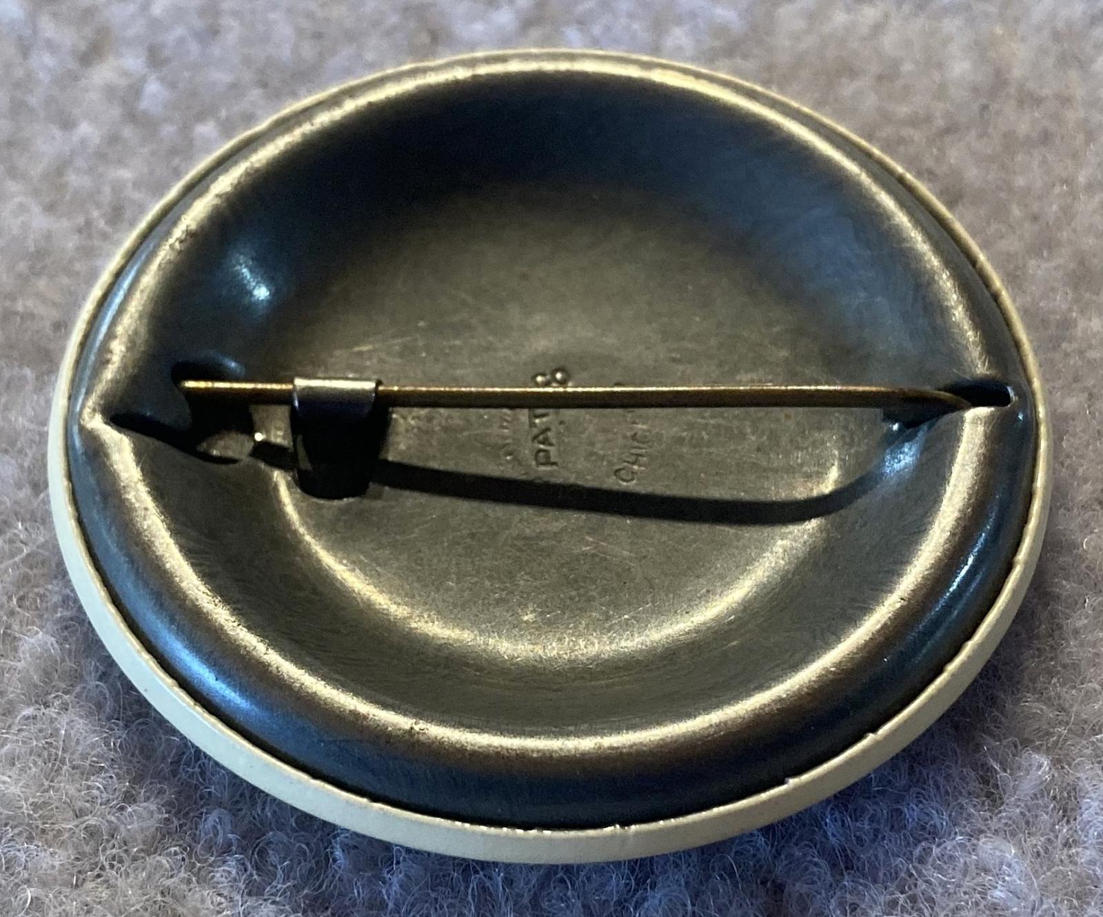 Reverse angled view of Cheer-Up Society Warden's badge