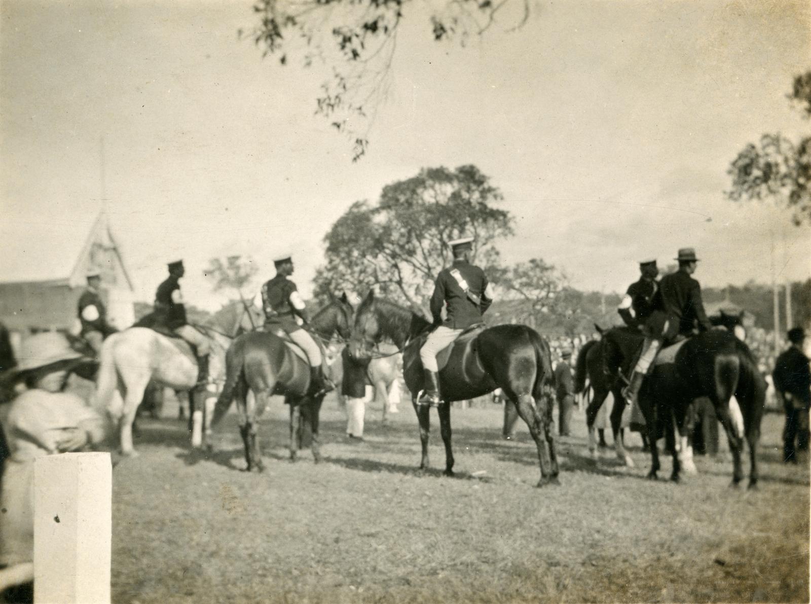 Black and White Photograph of Men on Horseback Front