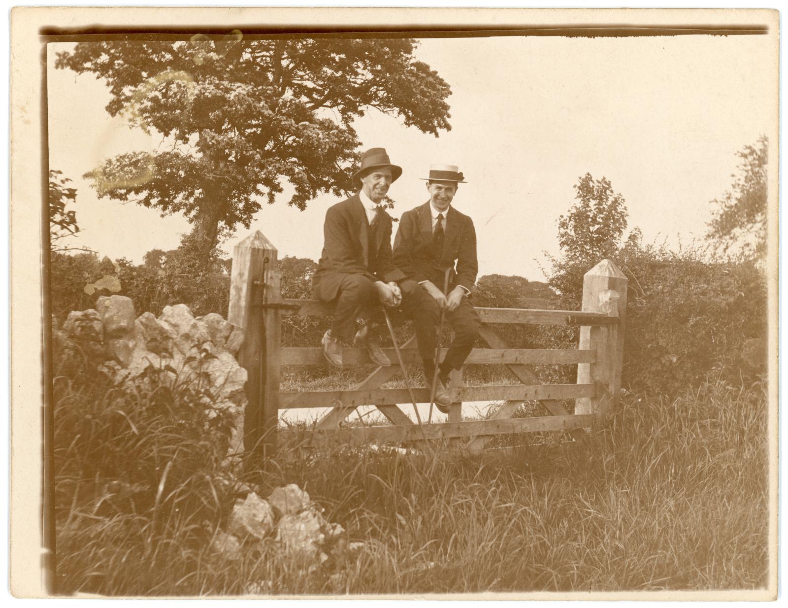 Photo of Raymond WARBURTON & friend sitting on fence gate
