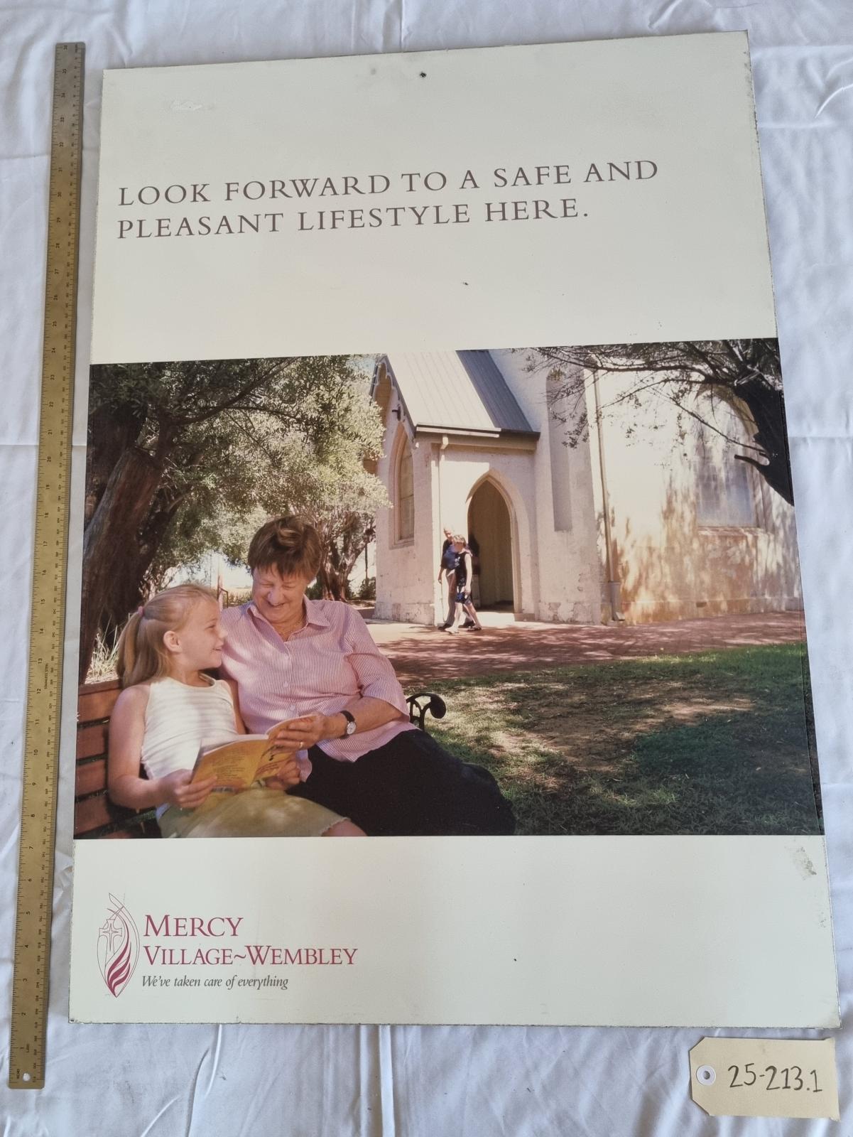25-213.1 Mercy village Wembley poster image with scale and tag.