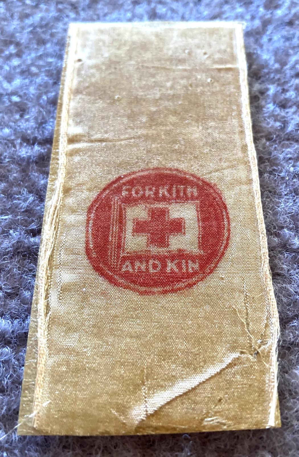 Angled view of WWI fundraising ribbon - For Kith and Kin, Red Cross Day 1915