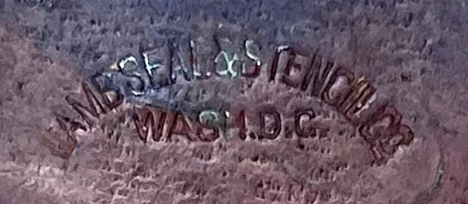 Close up of maker's details on reverse of plaque