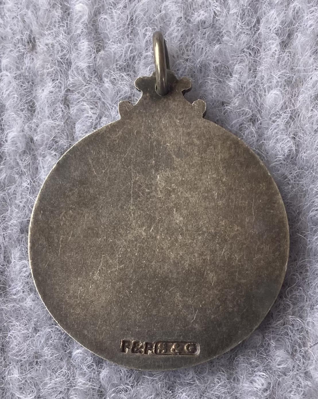 Reverse view of prize medallion for Boomerang mouth organ contest 