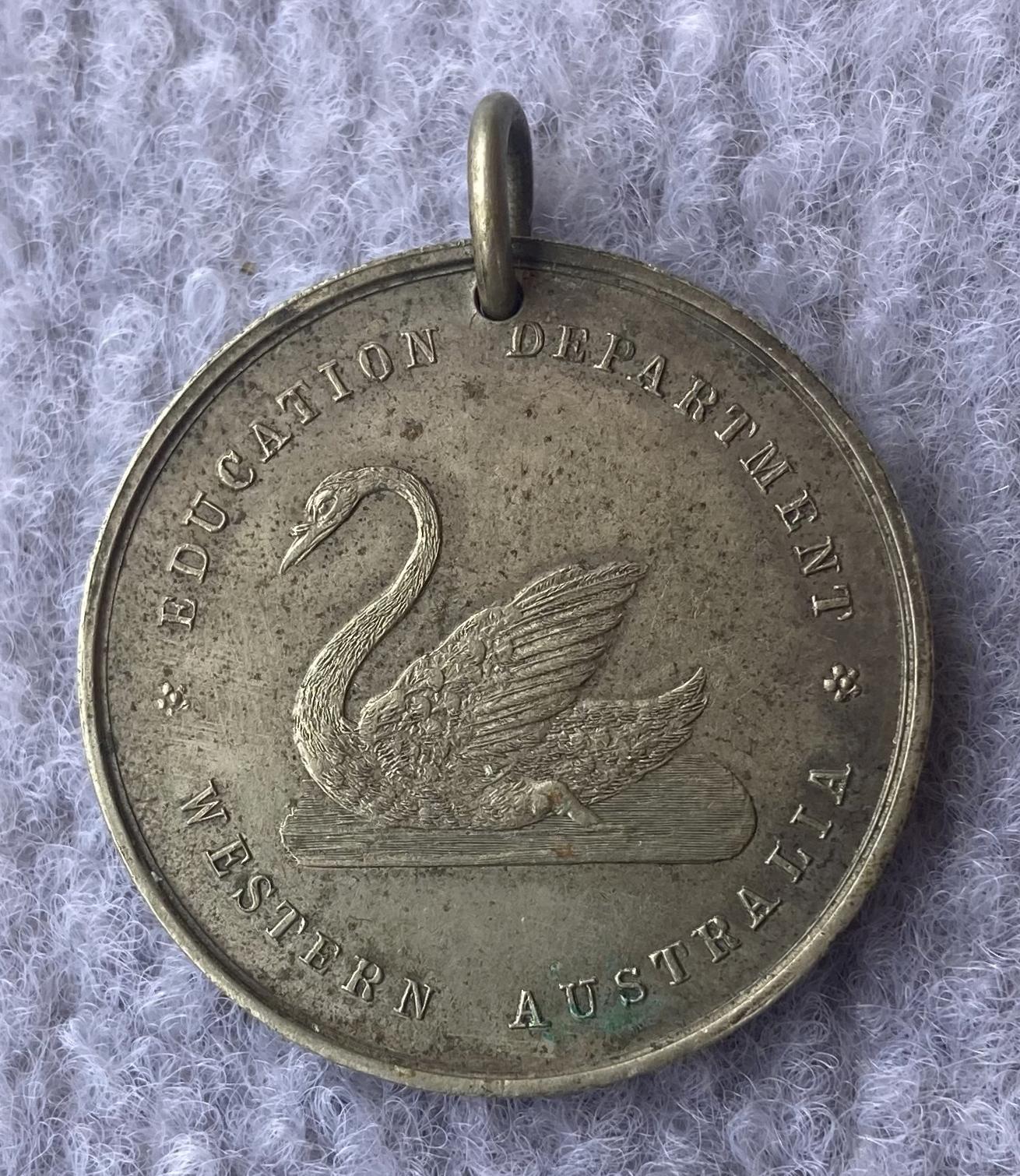 One side of Education Department of WA medallion issued to Irvine McKenzie