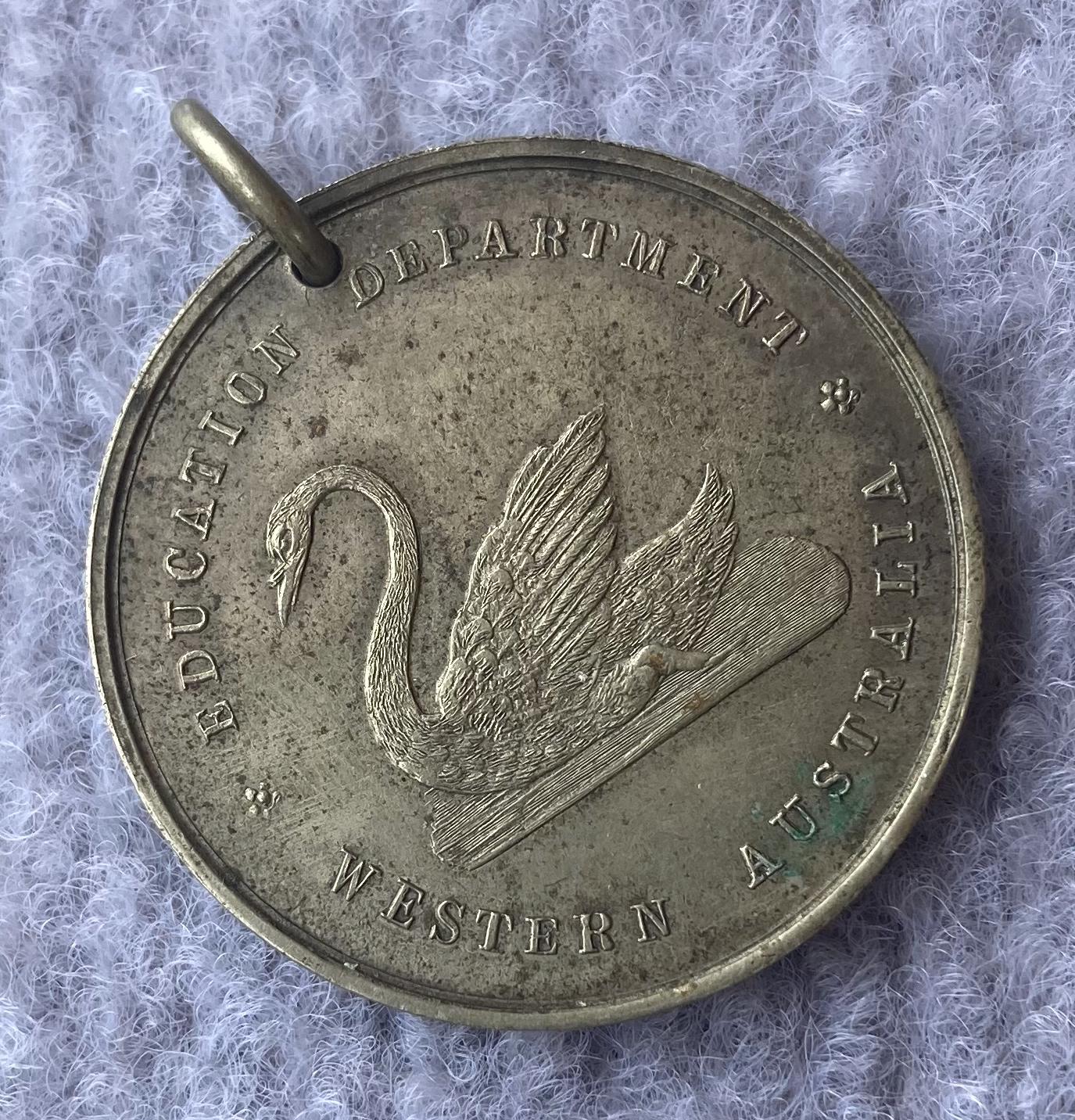 Oblique view of one side of Education Department of WA medallion 