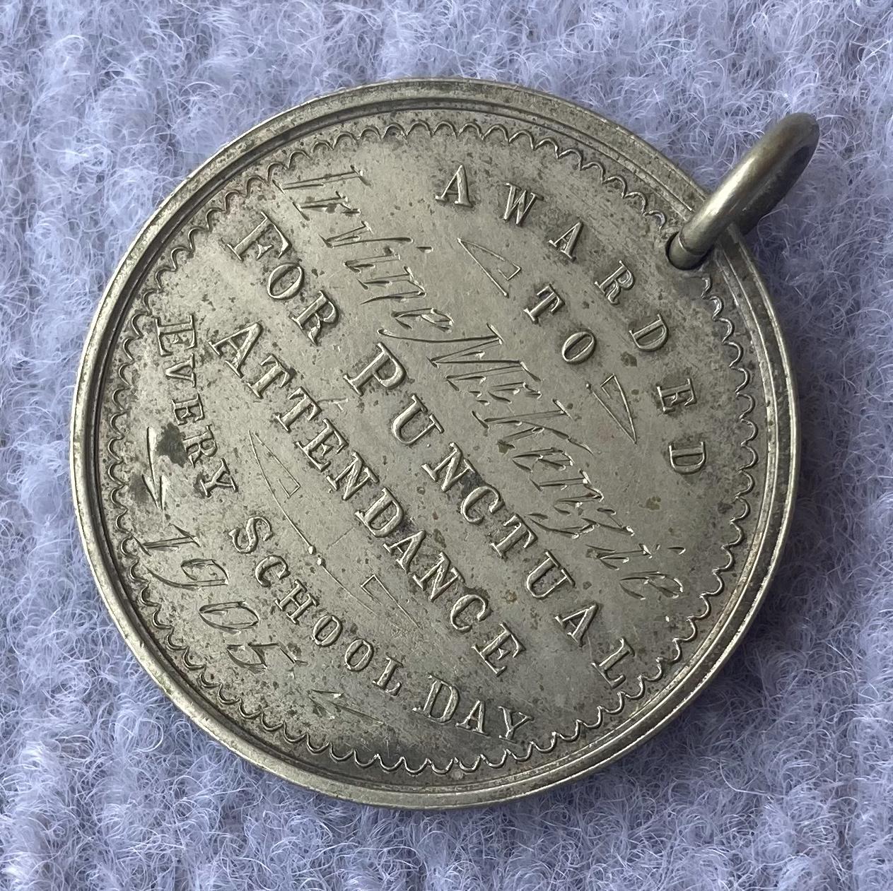 Other oblique view of engraved side of Education Department of WA medallion