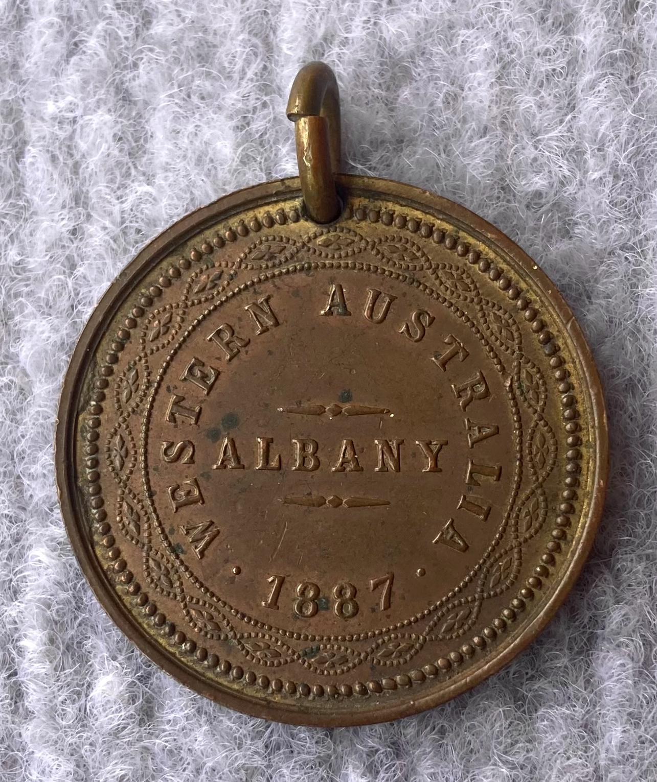 One side of medallion issued in Albany in 1877