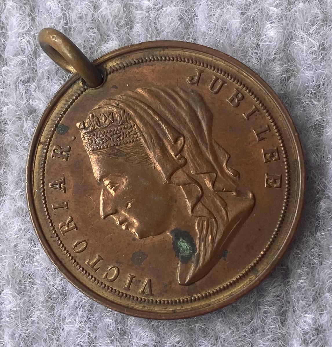 Oblique view of other side of a medallion issued in Albany in 1877