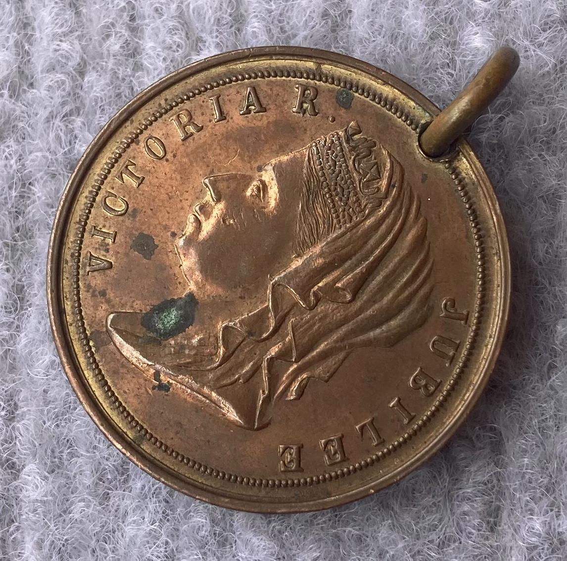 Other oblique view of other side of a medallion issued in Albany in 1877