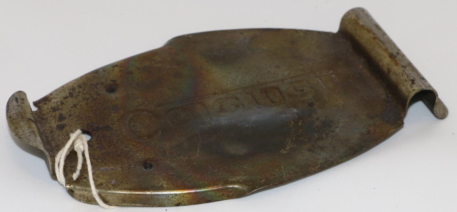 Metal base with 2 pointed ends, aluminium trivet, with ''Coleman'' pressed into base.