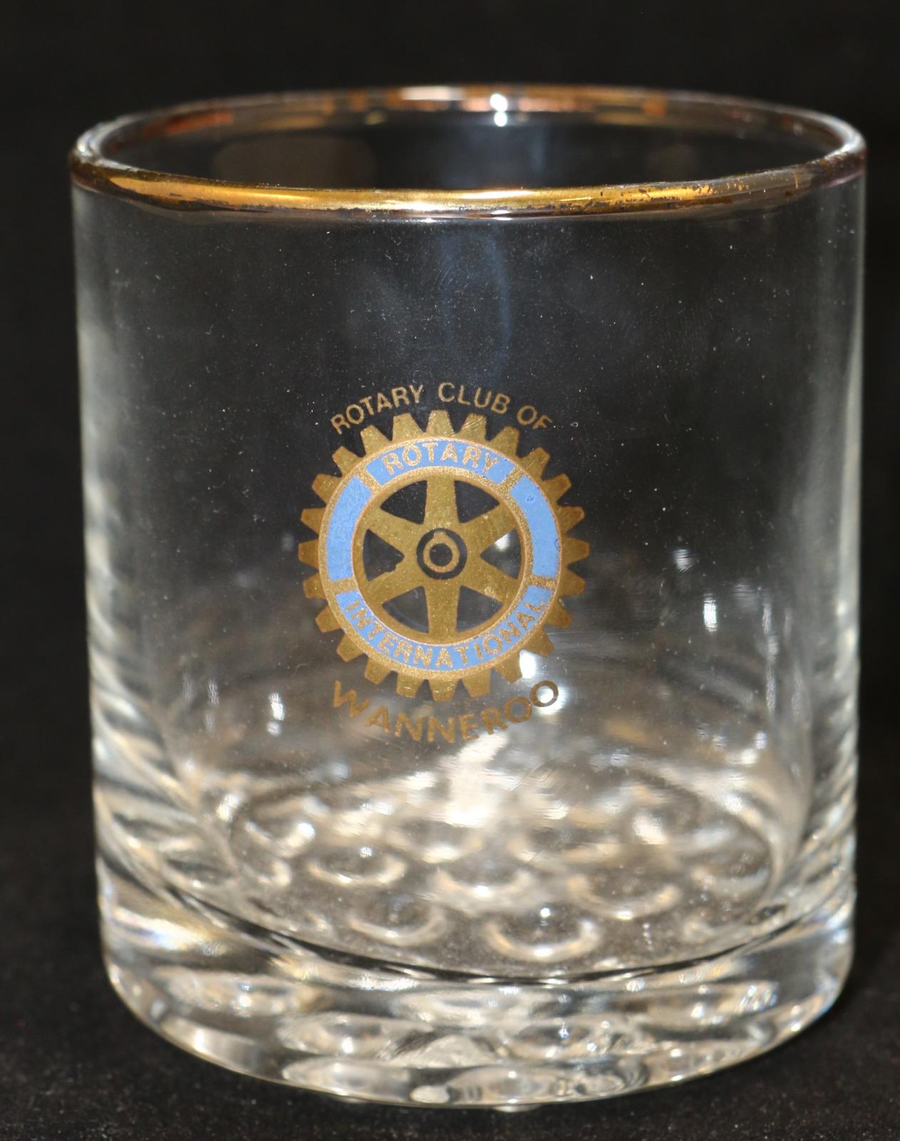 Glass tumbler with gold rim. Rotary Club of Wanneroo logo on the face in gold and blue.