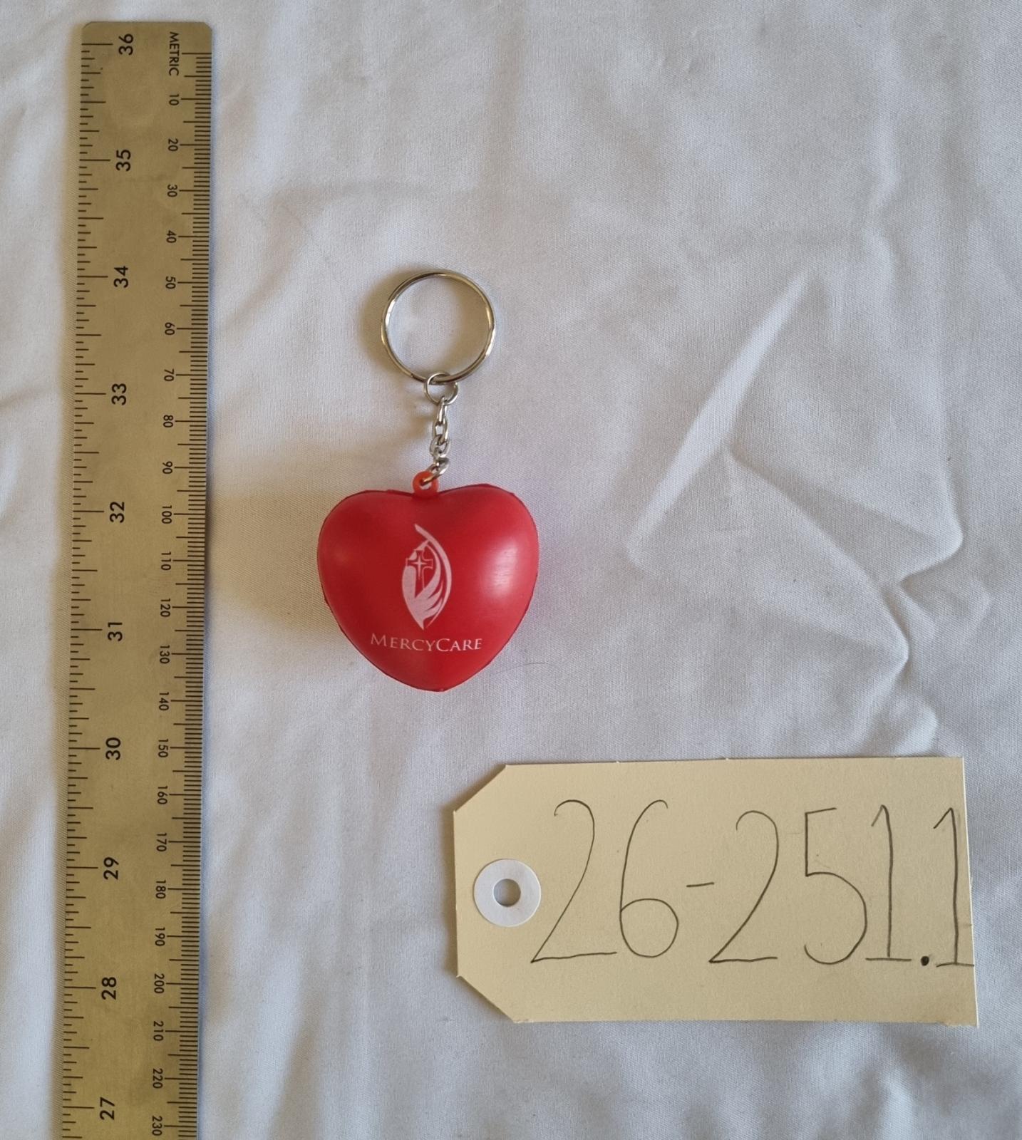 26-251.1 Heart Keychain with MercyCare Old Logo photo with scale and tag. 
