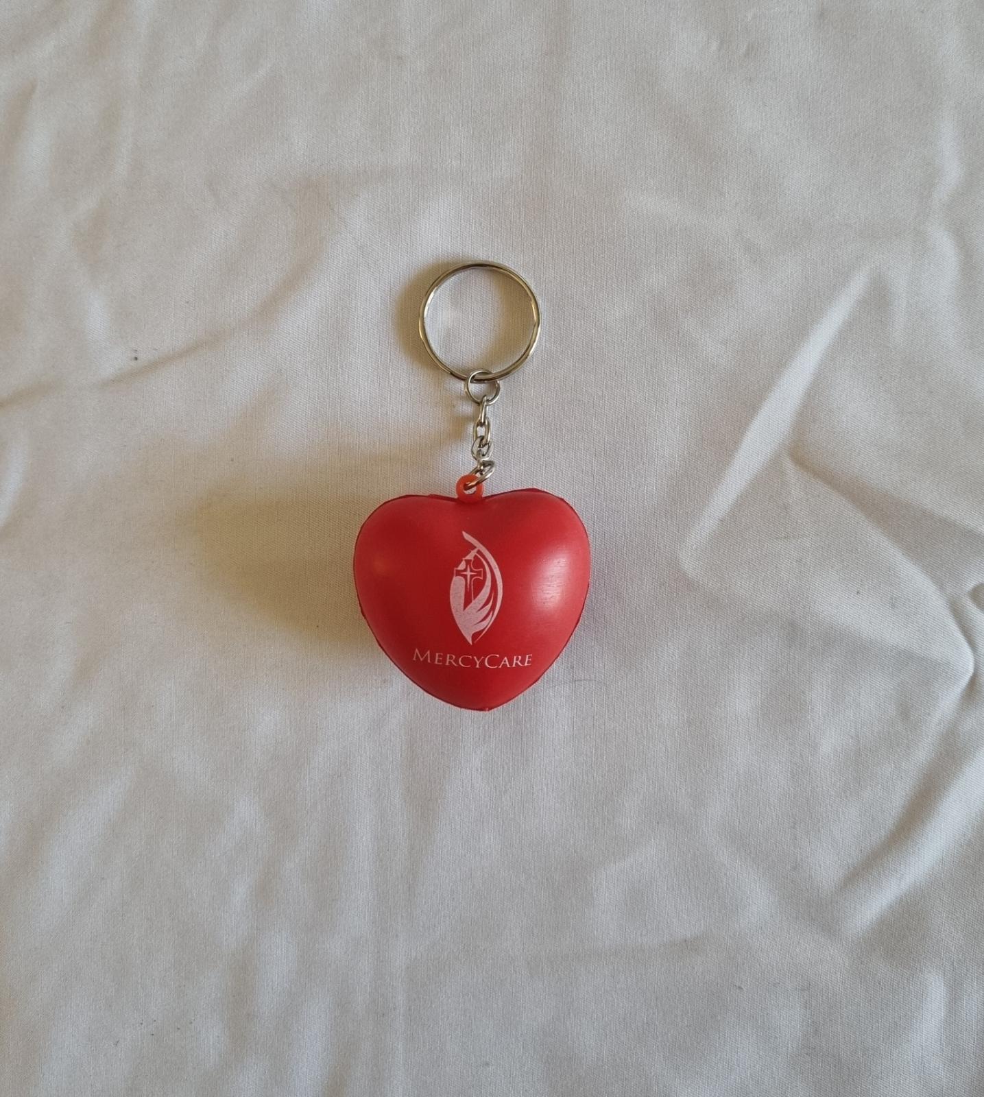 26-251.1 Heart Keychain with MercyCare Old Logo photo with background front-view.