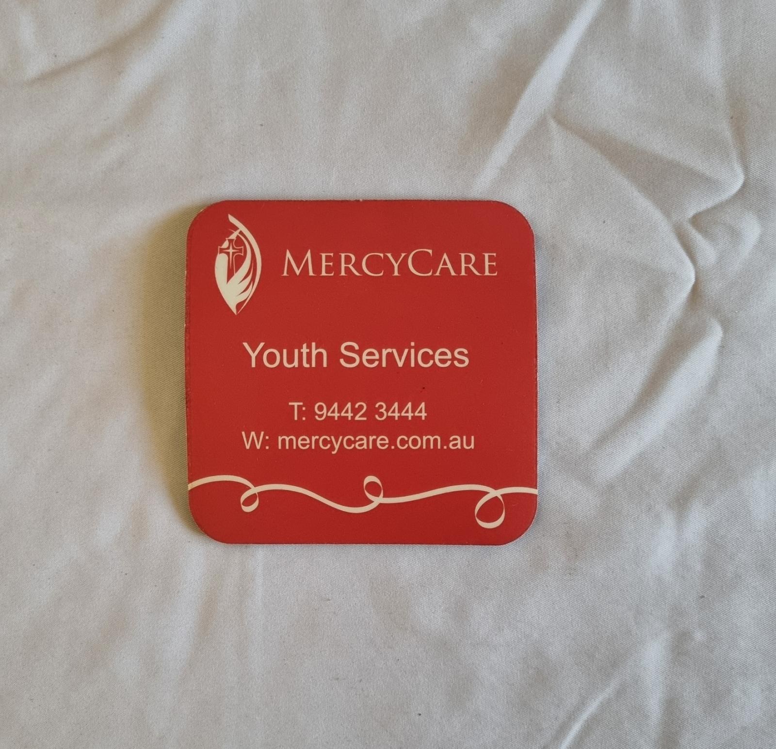 26-251.3 Coaster with MercyCare Old Logo photo with background front-view.