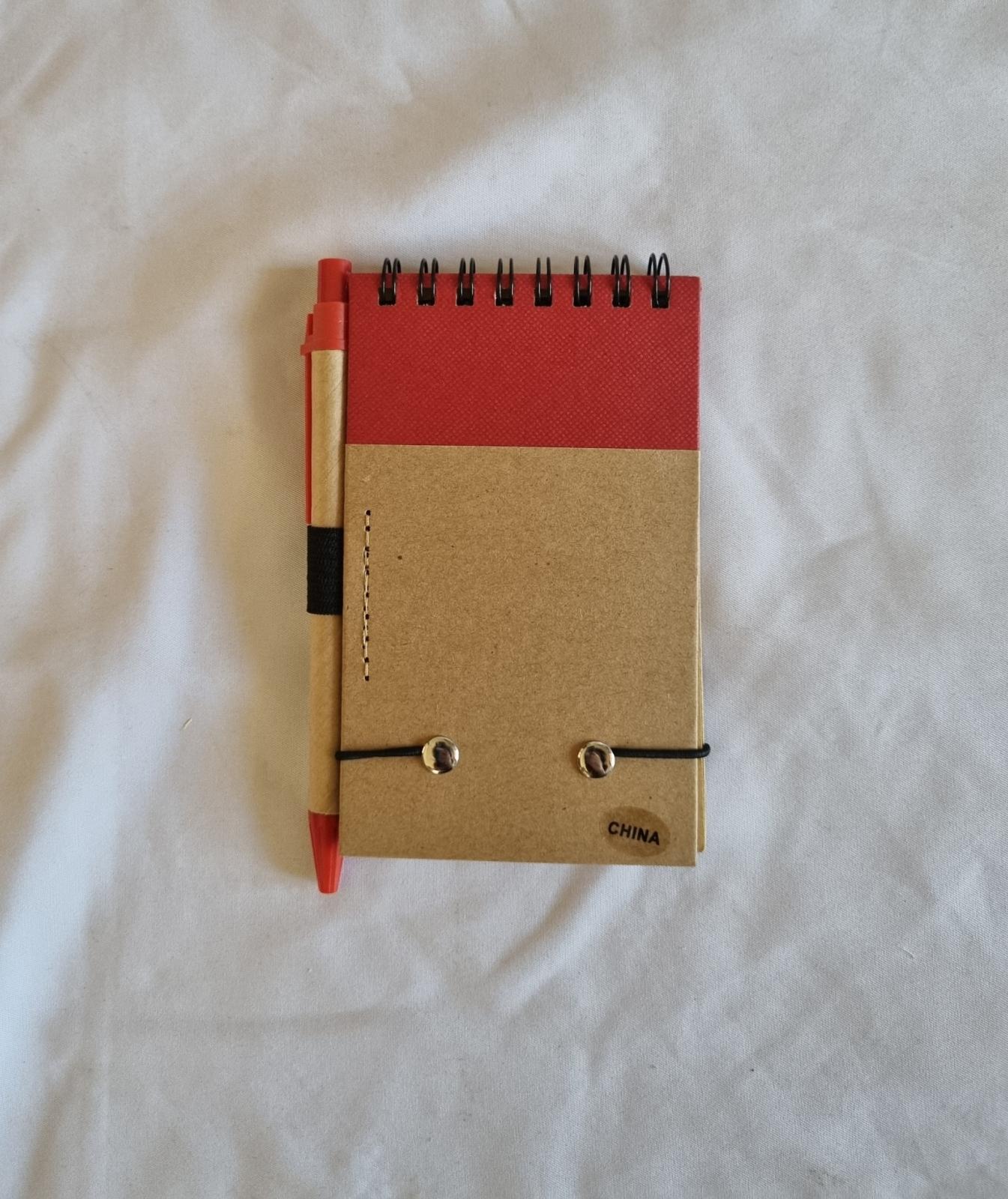 26-251.4 Notepad and Pen with MercyCare Old Logo photo with background back-view.