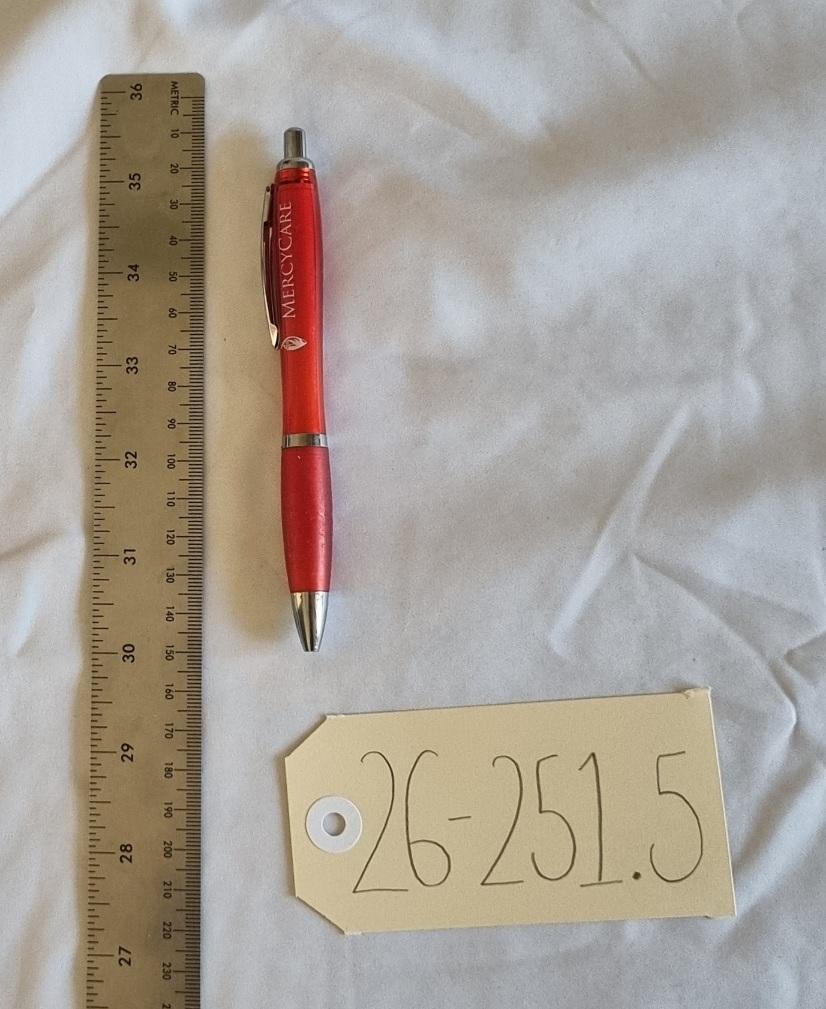 26-251.5 Red Pen with MercyCare Old Logo photo with scale and tag.