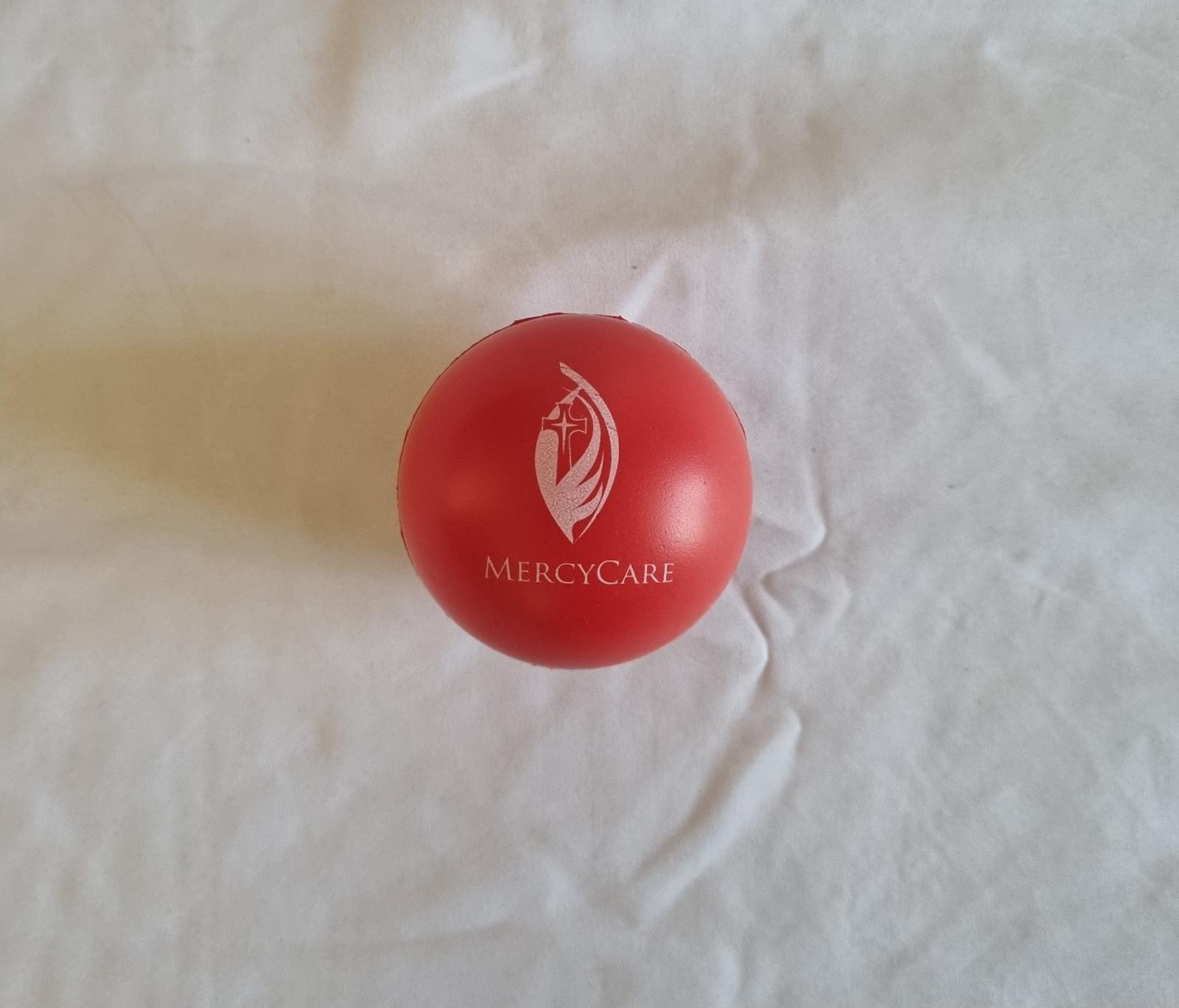 26-251.7 Red Foam Stress Ball with MercyCare Old Logo photo with background. 