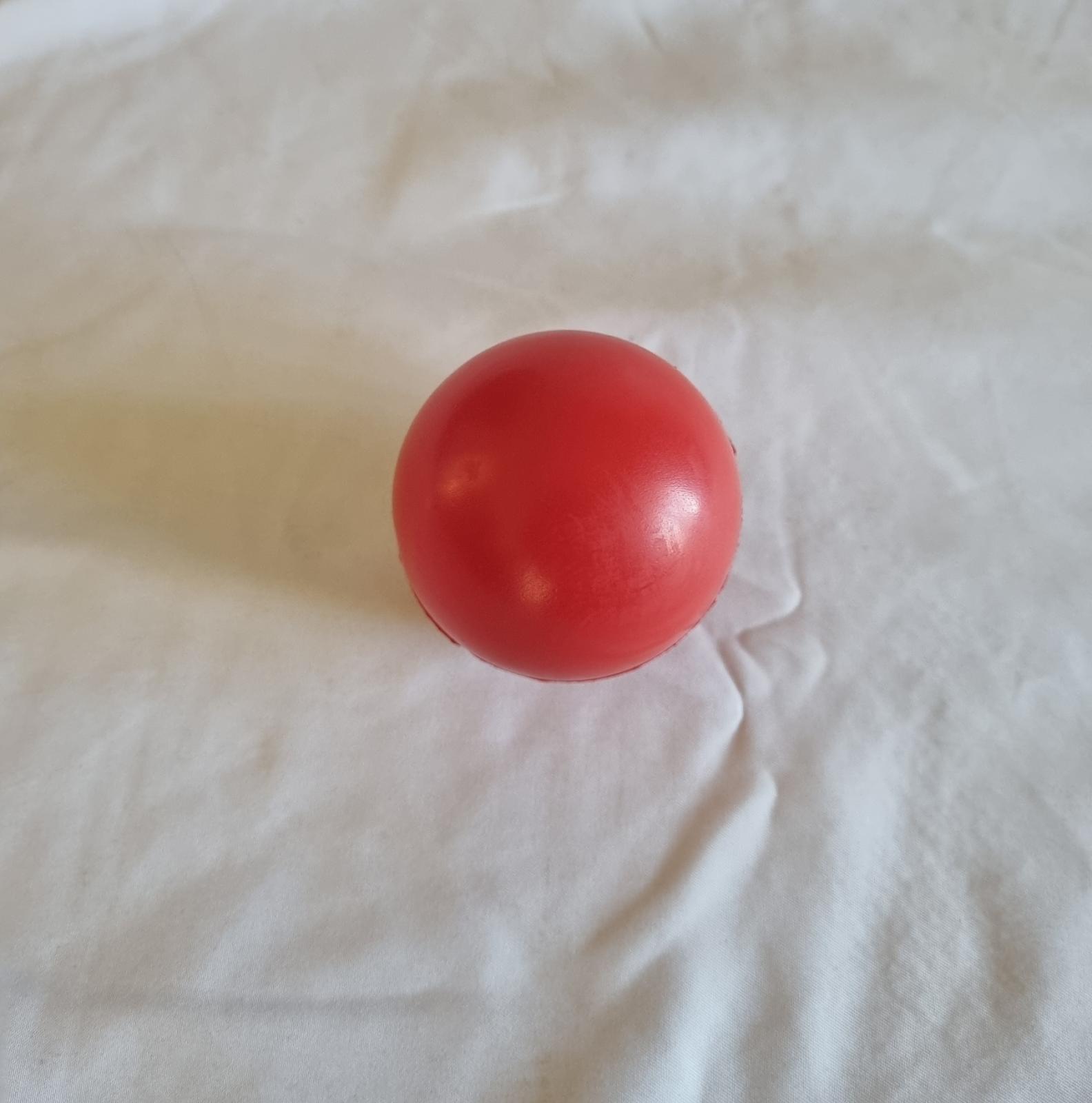 26-251.7 Red Foam Stress Ball with MercyCare Old Logo photo with background. 